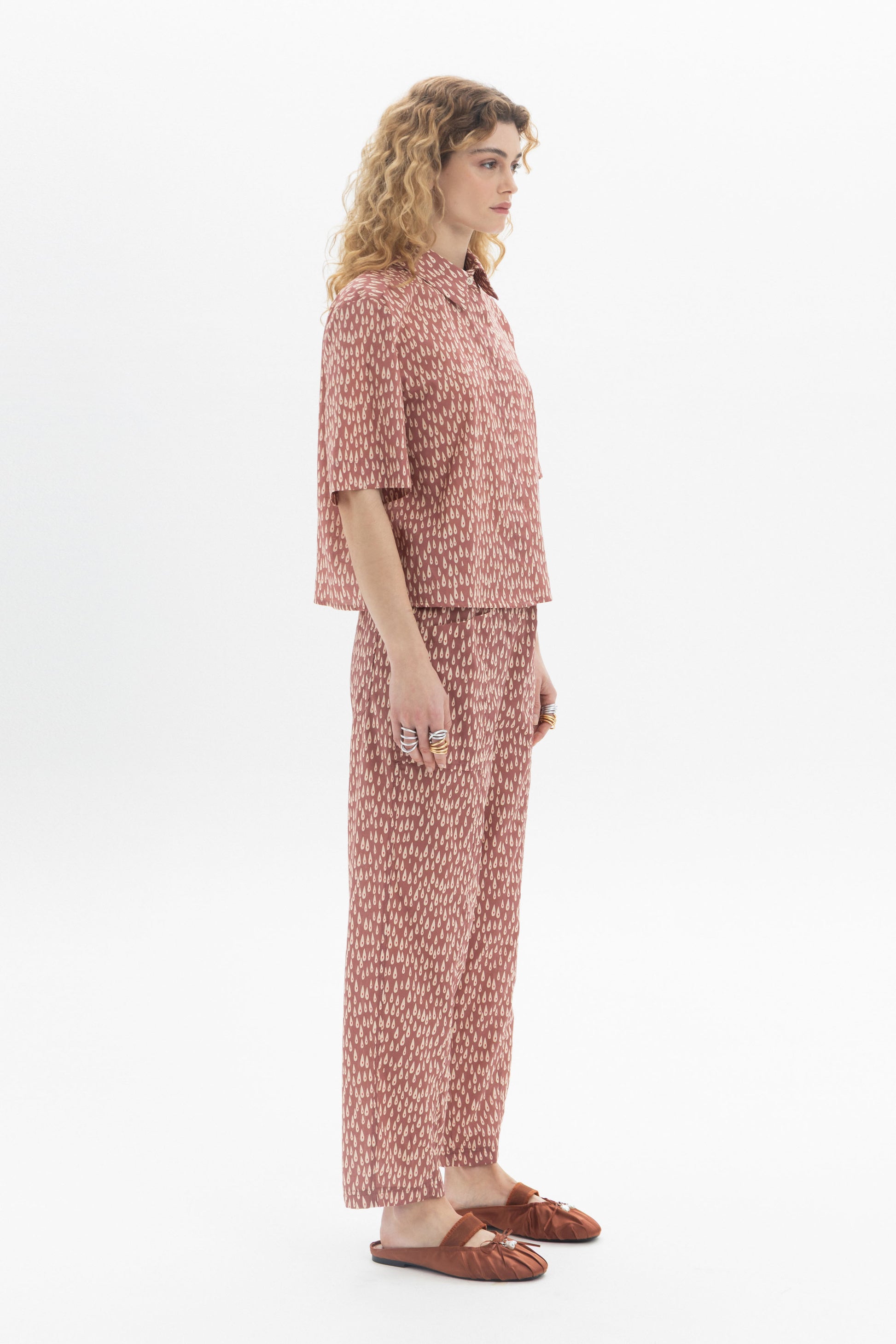 Model wearing a Short Sleeve Shirt with abstract print, styled with matching pants for a modern look.