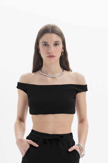 Black and Black B&B off-shoulder crop top featuring long sleeves and fitted design on a mannequin.