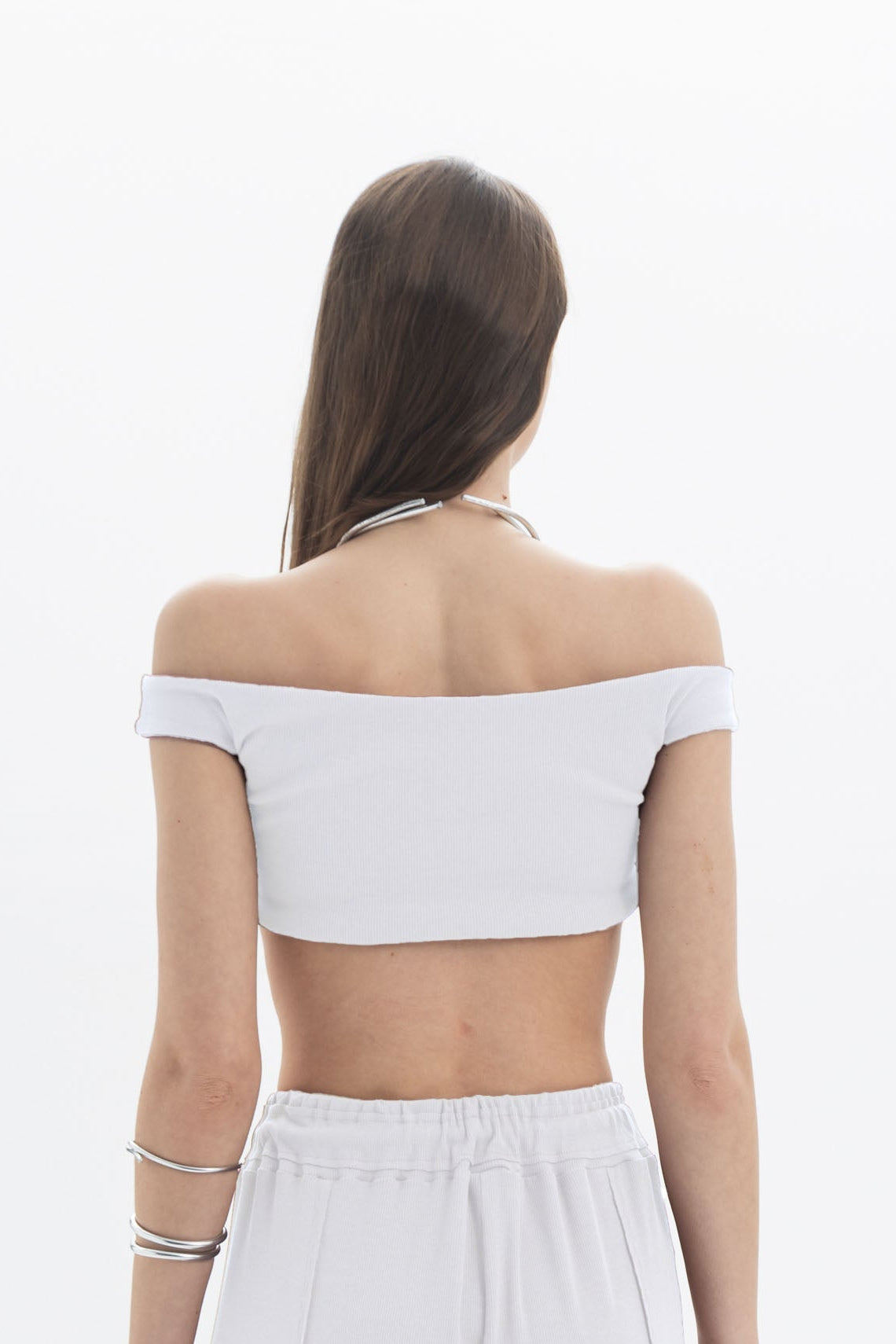 Black and Black B&B F Off-Shoulder Crop Top displayed on a hanger, showcasing its stylish black fabric and off-shoulder design.