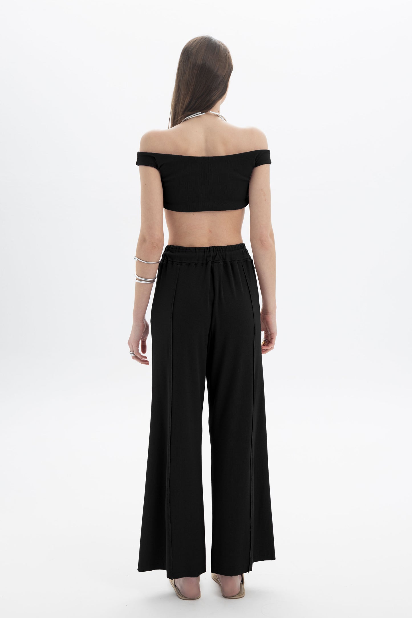 Black and Black B&B x F off-shoulder crop top in black with ruffled neckline and long sleeves, displayed on a mannequin.